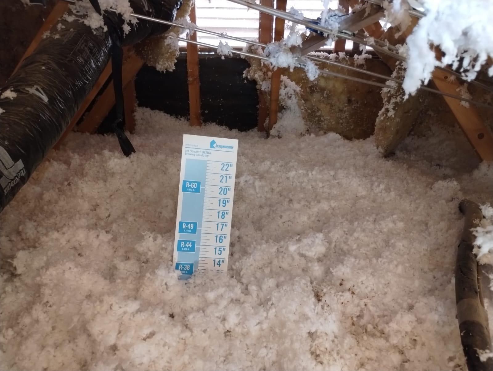 Blown-in insulation being installed in a Southern Arizona attic