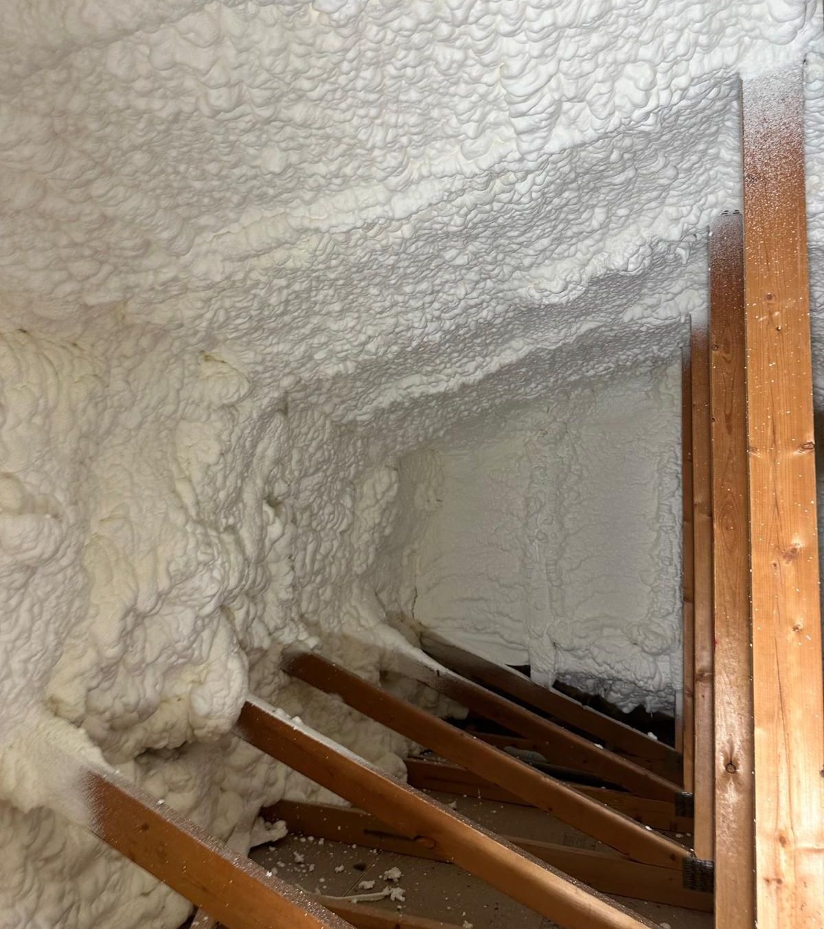 Open-cell foam expanding in an attic during installation